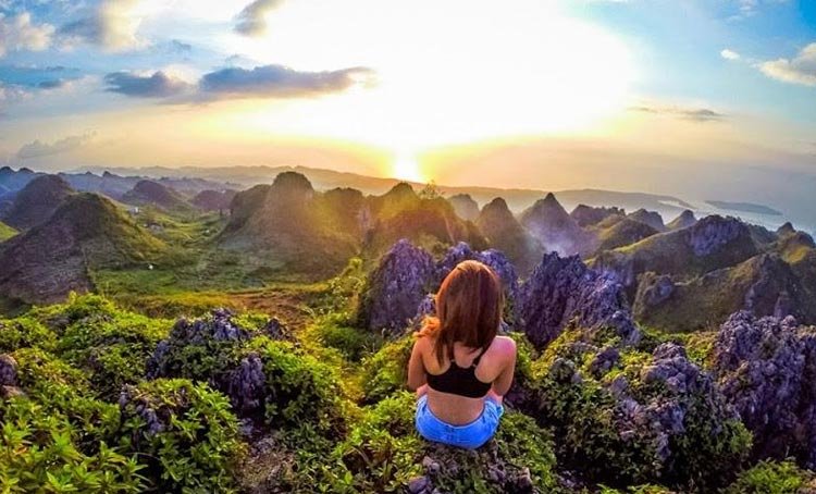 A girl sitting at the top of Osmena Peak