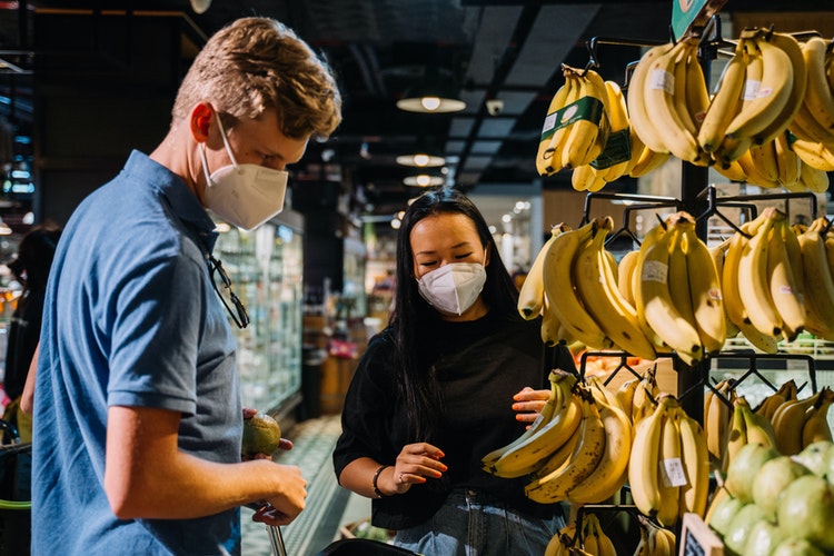 travelers buying bananas